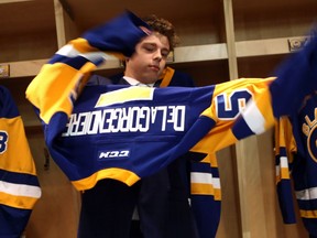 Saskatoon Blades draft pick Aidan De La Gorgendiere tries on his new jersey in the Blades dressing room at SaskTel Centre in Saskatoon on May 17, 2017.