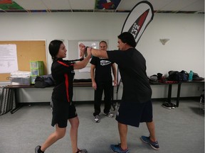 (Right to left) Founder of Fitness 2J2 Joel Pedersen, head instructor Leon Durette and class participant Renes Bill give a demonstration at a self-defence course held at White Buffalo Youth Lodge on Oct. 2, 2018.