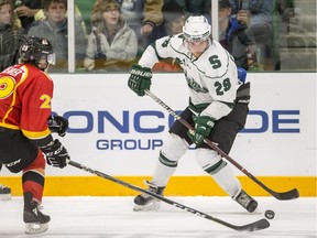 University of Saskatchewan Huskies forward Alex Forsberg moves the puck against the University of Calgary Dinos defence James Shearer during second period U Sport Hockey action at Merlis Belsher Place in Saskatoon, SK on Friday, October 12, 2018.