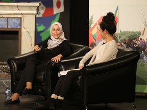 Dr. Alaa Murabit, UN High-Level Commissioner on Health Employment and Economic Growth, and Grade 12 student Jiaqi Shang sit onstage at Evan Hardy Collegiate for a discussion on being good 21st-century citizens on Oct. 12, 2018.