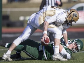 Huskies' defensive lineman Tristian Koronkiewicz drags down Manitoba QB Des Catellier Saturday afternoon at Griffiths Stadium.