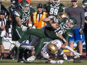 Huskies' quarterback Kyle Siemens is brought down after running for a first down during a victory this past weekend over Manitoba.