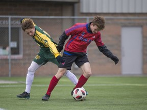 SASKATOON,SK--OCTOBER 26-1026-High School Soccer- Aden Bowman Bears Ben Hornick fights for the ball against Swift Current Colts Jaedyn Carefoot during the provincial 3A high-school soccer championships at  Kinsmen Field in Saskatoon,Sk on Friday, October 26, 2018. The championships wrap up Saturday.