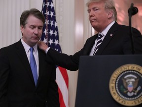 U.S. President Donald Trump puts his hand on Supreme Court Associate Justice Brett Kavanaugh's shoulder during his ceremonial swearing in in the East Room of the White House October 08, 2018 in Washington, D.C. Kavanaugh was confirmed in the Senate 50-48 after a contentious process that included several women accusing Kavanaugh of sexual assault. Kavanaugh has denied the allegations.