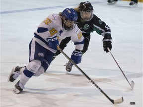 UBC Thunderbirds forward Hannah Clayton-Carroll fights for the puck against Huskies forward Kaitlin Willoughby during a Canada West women's playoff game at Rutherford Rink in Saskatoon on Saturday, February 24, 2018.