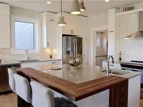 Executive Homes Builders' new show home at 226 Greyeyes-Steele Way in The Meadows is designed with family living in mind. The hub of the chef-worthy kitchen is a large quartz-topped island, trimmed with rich walnut. (Photo: Jeannie Armstrong)