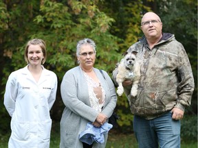 Dr. Danielle Zwueste, (left to right) Norma Tait, Toby and Kelly Tait pose for a portrait after Toby's recovery from a surgery that removed a large tumour from the top of his skull. (Taryn Riemer/ Western College of Veterinary Medicine)