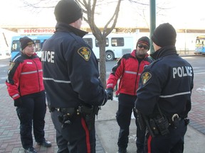 Community Support Officers (CSO) Jonathan Keens-Douglas, right, and Jill Meldrum, speak with members of the Saskatoon Police Service on Nov. 30, 2017. Able to receive dispatches both from police and the public, the city's CCSOs are in contact with police consistently throughout a shift, providing them regular updates on calls they've responded to, where they're located or if they need assistance.