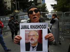 An activist, member of the Human Rights Association Istanbul branch, holds a poster with a photo of missing Saudi journalist Jamal Khashoggi, during a protest in his support near the Saudi Arabia consulate in Istanbul, Tuesday, Oct. 9, 2018. Turkey said Tuesday it will search the Saudi Consulate in Istanbul as part of an investigation into the disappearance of a missing Saudi contributor to The Washington Post, a week after he vanished during a visit there.