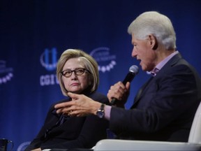 Former Secretary of State Hillary Clinton listens as former President Bill Clinton speaks during the annual Clinton Global Initiative conference at the University of Chicago on Oct. 16, 2018.