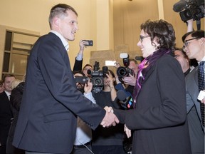 Newly elected mayor Charlie Clark shakes hands with defeated mayoral candidate Kelley Moore at city hall in Saskatoon on Wednesday, October 26, 2016.