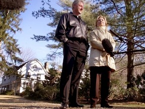 Bill and Hillary Clinton stand in the driveway of their new home in Chappaqua, N.Y. on Jan. 6, 2000.