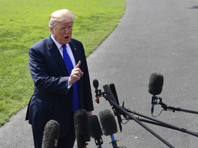 President Donald Trump talks with reporters on the South Lawn of the White House in Washington, Tuesday, Oct. 2, 2018, as he heads to Pennsylvania.