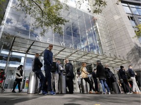 People gather outside the Time Warner Center, in New York, Wednesday, Oct. 24, 2018. A police bomb squad was sent to CNN's offices in New York City and the newsroom was evacuated because of a suspicious package.