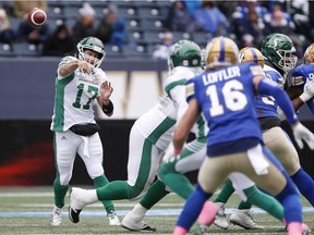 Saskatchewan Roughriders quarterback Zach Collaros (17) throws but it's intercepted by Winnipeg Blue Bombers' Taylor Loffler (16) during the first half of CFL action in Winnipeg Saturday, October 13, 2018.