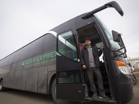 Firat Uray who is expanding Rider Express bus lines on the prairies poses with one of his new buses in Calgary, Friday, Oct. 26, 2018.
