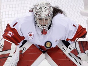 Goalie Shannon Szabados (1), of Canada, stares at the flying puck during the second period of the women's gold medal hockey game against the United States at the 2018 Winter Olympics in Gangneung, South Korea, Thursday, Feb. 22, 2018. Marie Philip-Poulin and veteran goaltender Szabados headline Canada's roster for the Four Nations Cup women's hockey tournament.