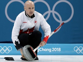 In this Feb. 23, 2018 file photo, Canada's skip Kevin Koe uses his broom to clean the stone during his game against Switzerland at the 2018 Winter Olympics in Gangneung, South Korea. (AP Photo/Aaron Favila, File)