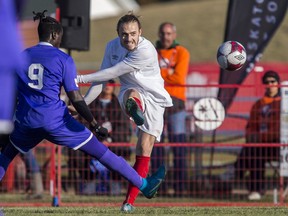 Saskatoon Revolution forward Shredrek Samuel attempts to stop a kick from Edmonton Scottish SC midfield Haris Kevac during the Challenge Trophy Toyota national club men's soccer championship recently in Saskatoon.