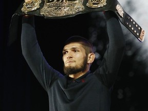 Khabib Nurmagomedov holds up a belt during a news conference for the UFC 229 mixed martial arts bouts Thursday, Oct. 4, 2018, in Las Vegas. Nurmagomedov is scheduled to fight Conor McGregor Saturday in Las Vegas.
