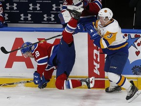 Edmonton Oil Kings Vince Loschiavo (left) is checked by Saskatoon Blades Jake Kustra during first period WHL hockey action at Rogers Place on Wednesday, Oct. 3, 2018.