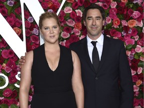 In this June 10, 2018 file photo, Amy Schumer, left, and Chris Fischer arrive at the 72nd annual Tony Awards in New York.  Schumer announced she's pregnant with husband Fischer. She broke her baby news Monday on the Instagram stories of friend and journalist Jessica Yellin.