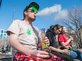 Regan Macdonald blows smoke after taking a pull on his Bart Simpson themed bong in Victoria Park in Regina where marijuana enthusiasts had gathered to smoke.