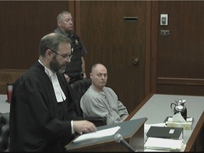 A Saskatoon man who was found guilty of killing his wife is appealing his conviction, saying the judge erred in directing the jury. David Woods, right, looks on as his lawyer, James Streeton, addresses the court in a still frame made from live stream video footage in Regina on Oct. 2, 2018. (Saskatoon StarPhoenix / CBC / Pool)