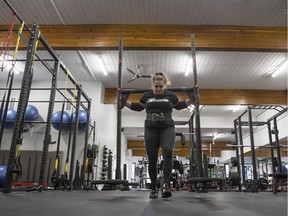 Jackie Bundus walks with a 365-pound yoke — one of the events she competes in as a pro strongwoman.