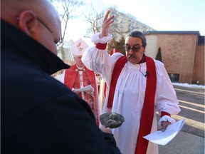 Chris Harper (right) takes part in a smudging ceremony with Corey McCafferty on his way into St. John's Anglican Cathedral on Nov. 17, 2018 to be ordained as bishop of the diocese in Saskatoon.