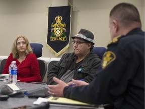 From left to right, Rhonda Beaudin and Kim Beaudin speak to Chief Troy Cooper at the Saskatoon Police headquarters on Nov. 16, 2018.