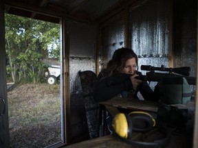 Sherri Lynn Usselman takes aim with a hunting rifle in her target shooting shack at her fathers farm in Allan