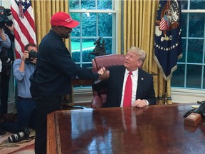 In this file photo US President Donald Trump meets with rapper Kanye West in the Oval Office of the White House in Washington, DC, October 11, 2018. - Rapper Kanye West, who has been outspoken in his support for President Donald Trump, now says he's going to focus on his music and fashion after being "used" in the world of politics, October 30, 2018.