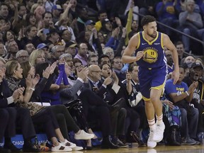 Golden State Warriors guard Klay Thompson (11) runs up the court after scoring against the Atlanta Hawks during the first half of an NBA basketball game in Oakland, Calif., on November 13, 2018. Warriors guard Klay Thompson called it a "potential preview of June." Golden State visits Toronto to face the red-hot Raptors on Thursday in what some are calling a sneak peak at this season's NBA Finals. Golden State is just one game in a stiff test for Toronto, as the Raptors are playing a gruelling stretch of the schedule against winning teams.