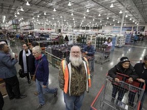 An original employee of the first location, 25-year Costco employee Darren Danylchuk, reflective vest, stands in the new store on Anaquod Road in the city's east end on Friday.