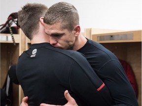 Ottawa Redblacks quarterback Trevor Harris, right, is consoled after Sunday's Grey Cup loss to the Calgary Stampeders.