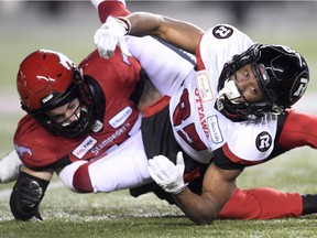 Ottawa Redblacks wide receiver Diontae Spencer (85) fumbles the ball as Calgary Stampeders linebacker Riley Jones (52) looks on during the second half of the 106th Grey Cup at Commonwealth Stadium in Edmonton, Sunday, November 25, 2018.