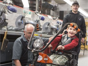Rob Gilchrist, Saskatchewan Polytechnic Instructor, program head, and some of his students attach a new part to Henry Craig-Van Vliet', a 7 yrs old, grade 2 student, who was born with Cerebral Palsey, wheelchair, as an upgrade for Halloween, at Saskatchewan Polytechnic on Thursday, October 29th, 2015. The Motorcycle inspired addition to the boy's wheelchair was done by Rob Gilchrist, Saskatchewan Polytechnic Instructor, program head, and some of his students.