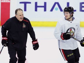 Ottawa Senators assistant coach Martin Raymond (left) shares a laugh with Max McCormick during a Senators team practice in Ottawa on Tuesday, November 6, 2018.
