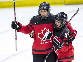 Canada's Rebecca Johnston celebrates a goal with Kristin O'Neill Friday against Finland.