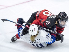 Canada defence Halli Krzyzaniak knocks United States forward Brianna Decker to the ice during third period of 2018 Four Nations Cup preliminary game in Saskatoon on Wednesday, November 7, 2018. The United States defeated Canada 2-1.