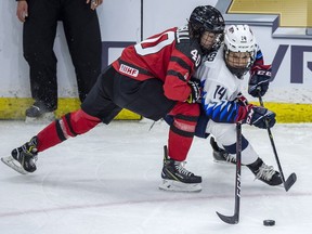 Canada forward Blayre Turnbull and United States forward Brianna Decker battle for the puck during the first period of 2018 Four Nations Cup preliminary game in Saskatoon on Wednesday, November 7, 2018.