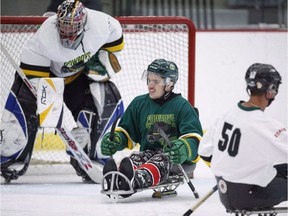 Humboldt Broncos bus crash survivor Ryan Straschnitzki, centre, plays in a fund raising sledge hockey game in Calgary, Alta., Saturday, Sept. 15, 2018. Seven months after they were both paralyzed in the Humboldt Broncos bus crash, Ryan Straschnitzki and Jacob Wasserman will finally have a proper reunion.