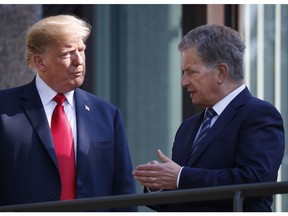 FILE - In this July 16, 2018 file photo, U.S. President Donald Trump, left, talks with Finnish President Sauli Niinisto as they pose for a photo in Helsinki, Finland. Niinisto said in an interview published on Sunday, Nov. 18, 2018 that he briefed Trump in the wake of the California wildfires on how the Nordic country effectively monitors its substantial forest resources with a well-working surveillance system.