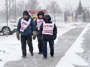 Saskatoon Co-op employees walk a picket line outside of the Co-Op gas station and grocery store on 33rd Street West in Saskatoon on Nov. 5, 2018.