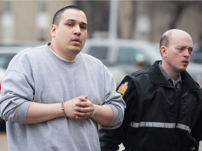 Christopher Pascal, left, walks in custody toward the Court of Queen's Bench to make an appearance after being charged with murder.