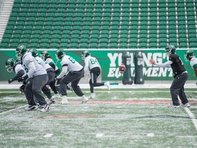 Saskatchewan Roughriders quarterback Zach Collaros, in black, takes a snap at practice on Wednesday at Mosaic Stadium