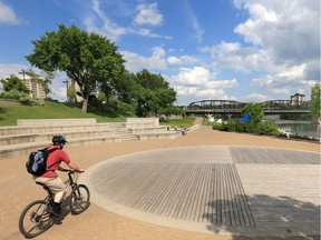 A cyclist enjoys the promenade at River Landing in Saskatoon in this July 22, 2014 photo.