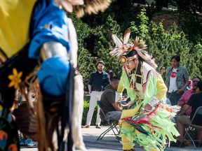 A dancer performs a ceremonial dance at a flag raising ceremony to honour Indian residential school and Sixties Scoop survivors in Saskatoon, Sask., Tuesday, May 29, 2018. Saskatchewan's minister of social services is hopeful his government will have a '60s Scoop apology by year's end.