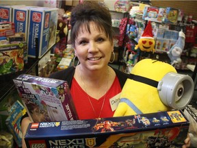 Debra Prosofsky, Salvation Army Toy Shop Co-ordinator, carries an armful of toys at the organization's toy shop, located in Saskatoon's Greystone Heights neighbourhood. She said the organization helps thousands of families every year and gives people a chance to experience the Christmas spirit, even if times are hard.